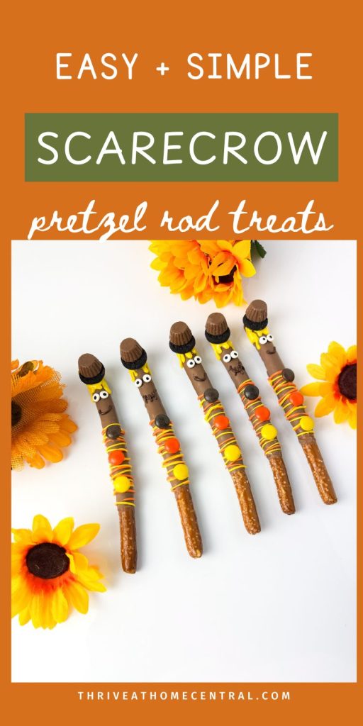 Five decorated pretzel rod treats resembling scarecrows are arranged on a white surface with artificial sunflowers and an orange background with text describing the treats.